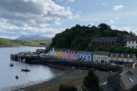 Explore Portree — Skye’s vibrant harbour town lined with postcard-perfect colourful houses.
