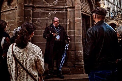 Kieran at Mercat Cross with people listening