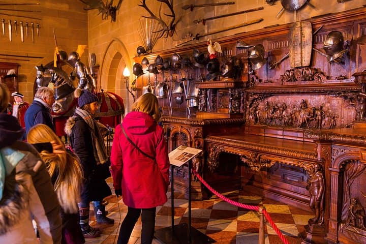 Curious visitors take time to appreciate the walk-through exhibits which provide historical context at Warwick Castle.