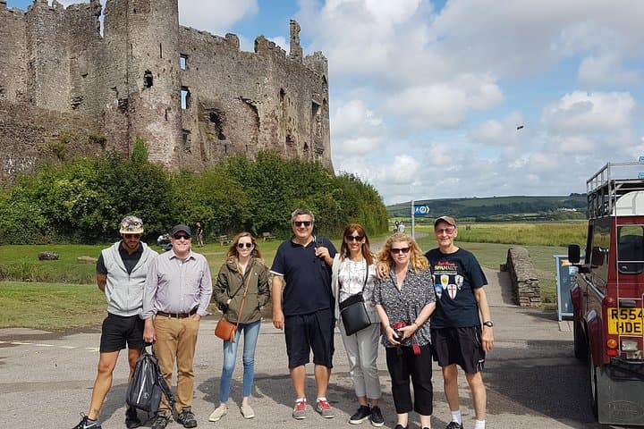 A tour arrives at Laugharne.