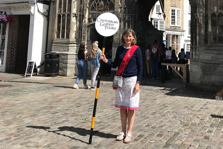 Our Guides will be wearing a red sash and holding a placard