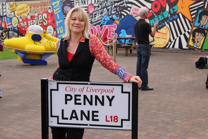 Penny Lane road sign, bank, shelter in the middle of a roundabout & John Lennon statue