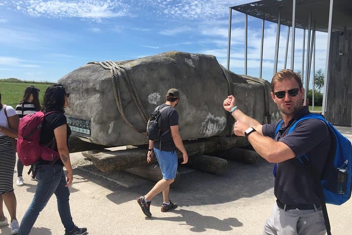 Our Expert Tour Guide Simulates Dragging A Stone