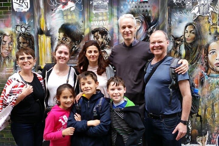 Guests in front of a street art mural