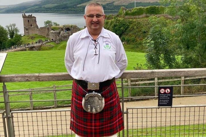 Your guide Ken at Urquhart Castle — storytelling, scenery, and a dram of Highland charm.