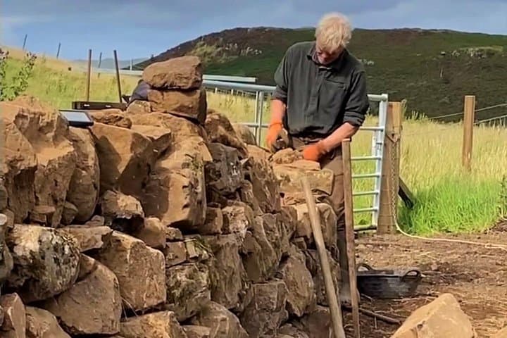 The farmer maintaining a traditional drystone wall