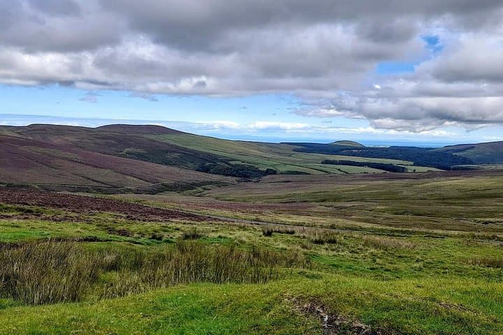 Rolling hills and uplands with the sea in the distance