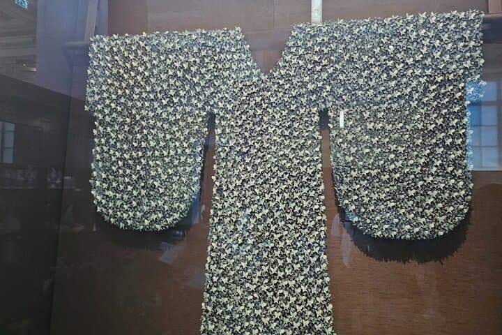 Ceramic sculpture in the form of a linen (burlap) robe sewn all over with porcelain butterflies