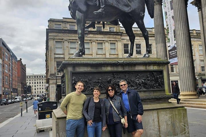 Our walking tour guests in Glasgow by the Duke of Wellington statue