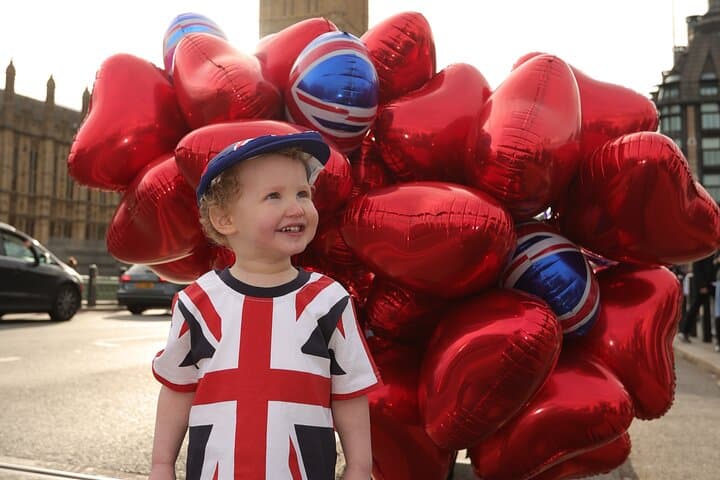 Kid wearing Union Jack t-shirt with balloons in the back