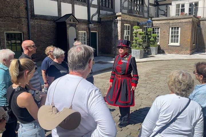 A royal moment! A crowd gathers around a Beefeater, eager to hear tales from the Tower of London's rich history.