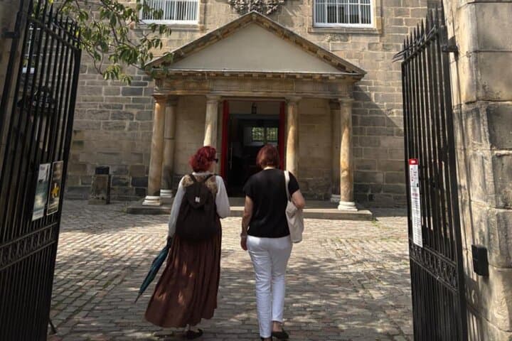 Charlotte and visitor entering Canongate Cemetery