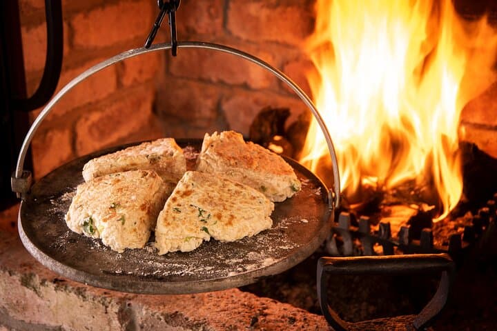 Soda farls cooking over a turf fire.