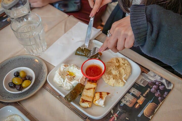 A flavourful platter of hummus, dolma, and halloumi