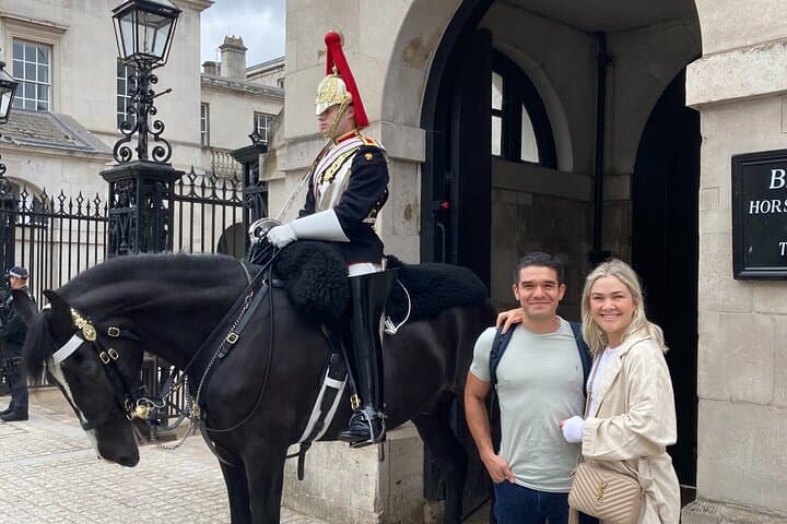 Horse guard with guests beside the archway