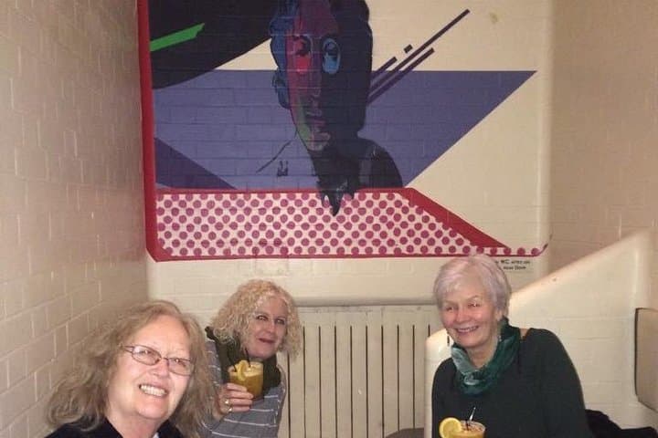 These tourists enjoying a drink in a very famous former prison cell!
